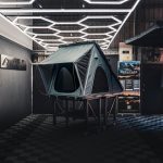 Grey Skytop Series rooftop tent mounted on 4WD during remote camp setup